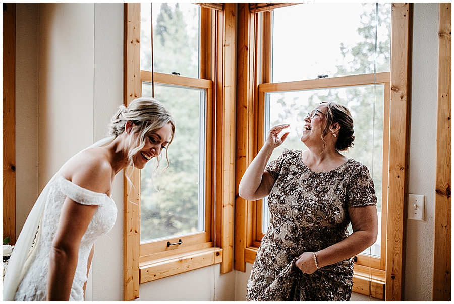 bride and mom laughing