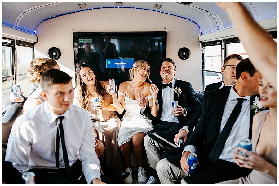 bride and groom singing on party bus