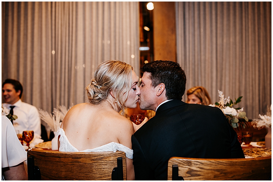 bride and groom kissing during reception